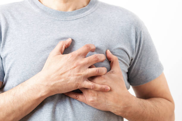 istock man holding his chest in pain 1303655668