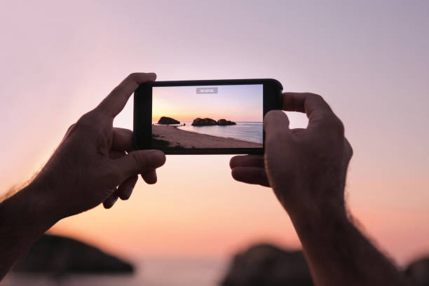 istock Tourist shooting with smartphone at sunset. 1303656072