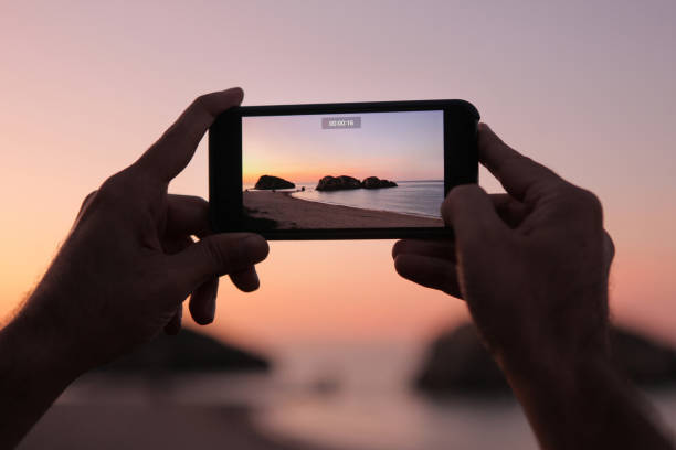 istock Tourist shooting with smartphone at sunset. 1303656075
