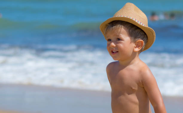 istock Beautiful Child Smiling On The Beach. 1303656825