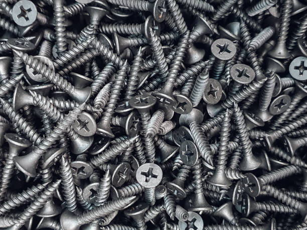 istock Screws. Black steel  screws for background. 1303657330