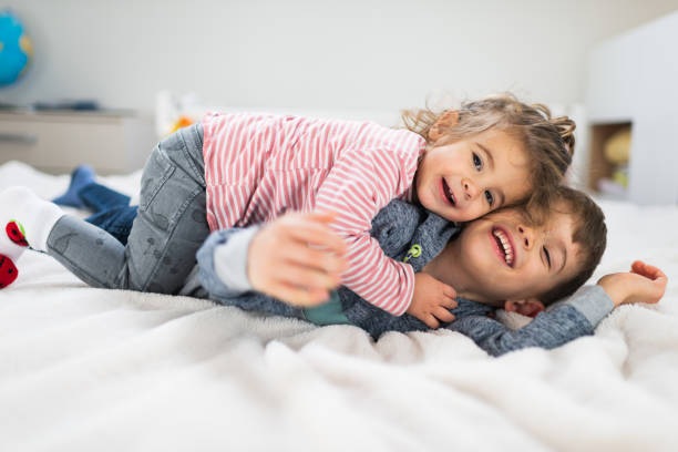playful brother and sister - criança de 1 a 2 anos imagens e fotografias de stock