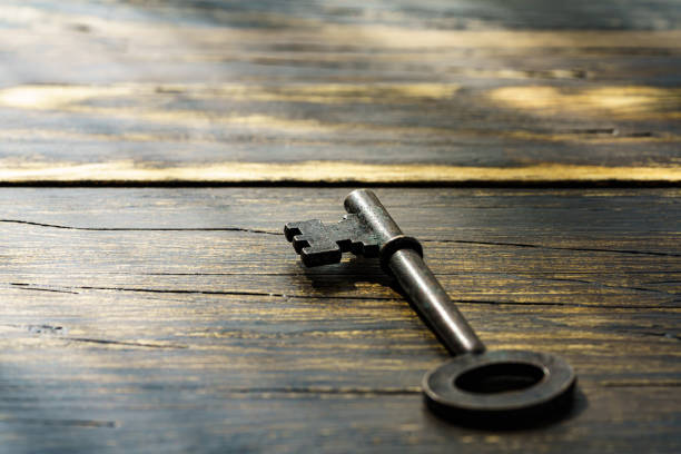 istock Vintage key on wooden table 1303659129