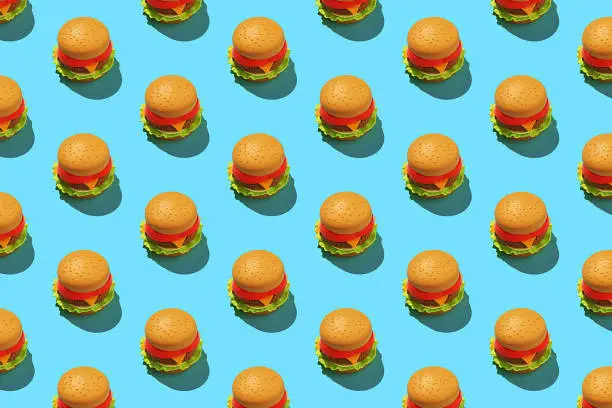 Minimalist hamburger pattern on blue background.