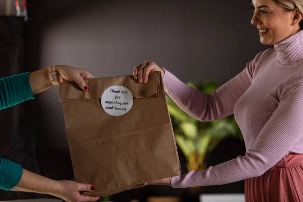 istock Giving loyal customer a care package with ''thank you'' label 1303661162