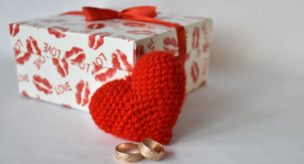 istock Wedding rings against handmade heart and gift box. 1303662993