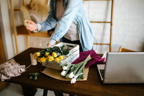 istock Young woman arranging bouquet 1303662998