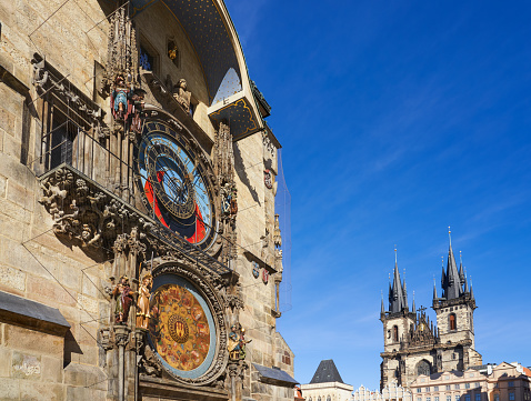 Prague astronomical clock and Church of Our Lady before Týn facade.