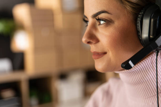 istock Woman with headset looking away during a conference call 1303663931