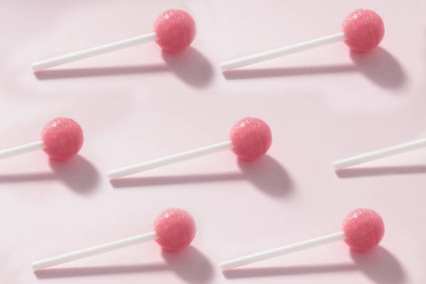 istock Pattern of pink candies on a stick 1303664167