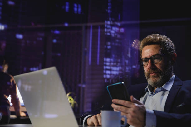 istock Serious businessman reading a text message on smart phone 1303665754