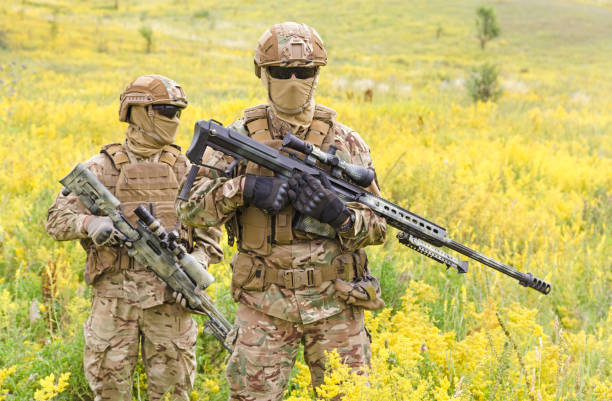 istock Two special forces soldiers with rifles in the field 1303666568