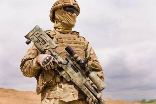 istock Special forces soldier with rifle close-up 1303666602