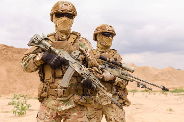 istock Two equipped and armed special forces soldiers 1303666643
