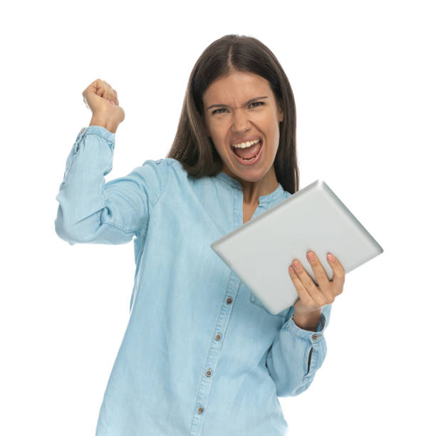 istock casual woman feeling excited and holding a tablet 1303666863