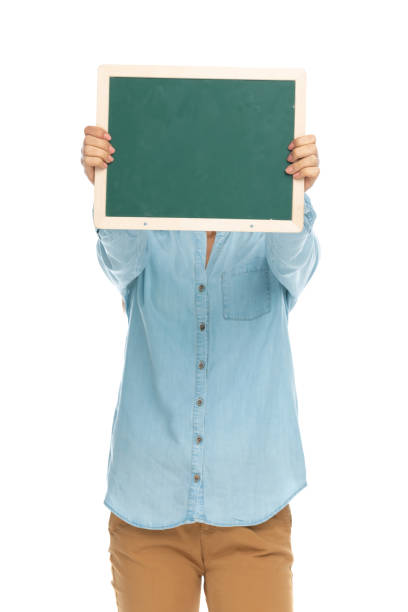 istock casual woman hiding her face behind a green board 1303668162