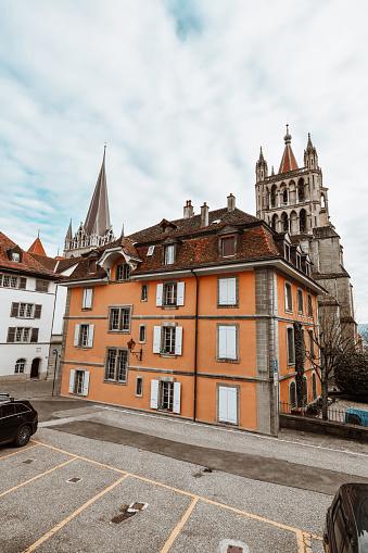 Cars Parked On Alleyway Behind Notre Dame In Lausanne, Switzerland