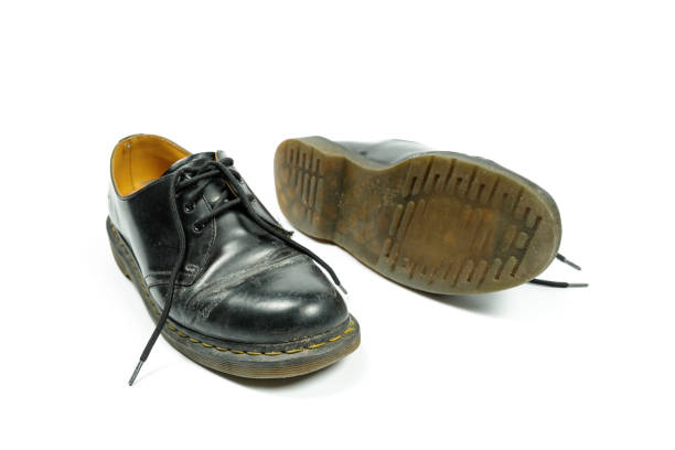 istock old, dirty, black leather shoes isolated on white 1303669938