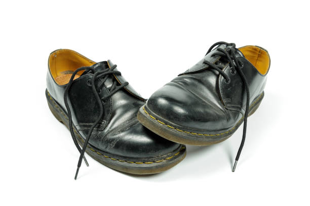 istock old, dirty, black leather shoes isolated on white 1303669962
