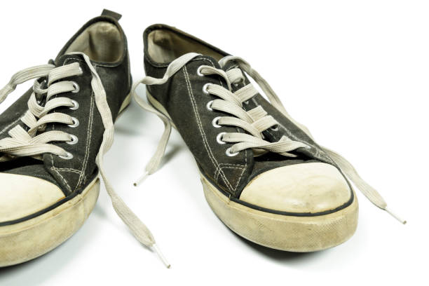 istock old, dirty trainers isolated on white 1303669988