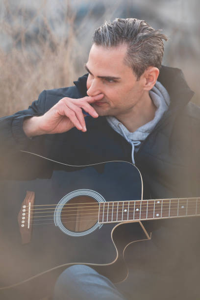 istock Musician plays an elegant black guitar, Spain. 1303670577
