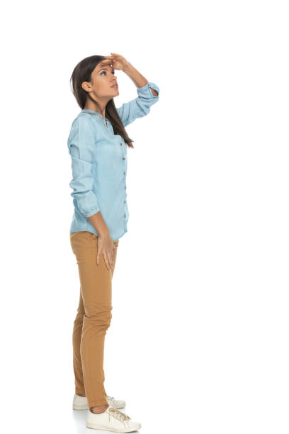 istock casual woman protecting her eyes from the sunlight 1303670618