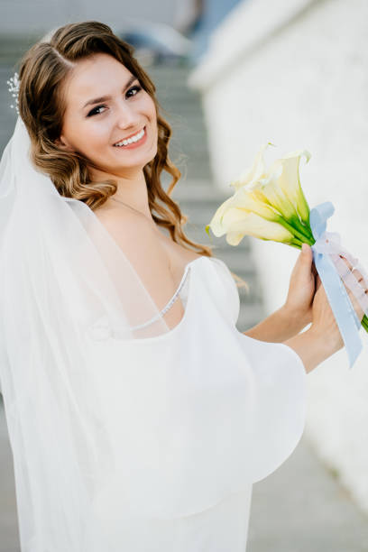 istock bride with long curls in a white elegant dress 1303671336
