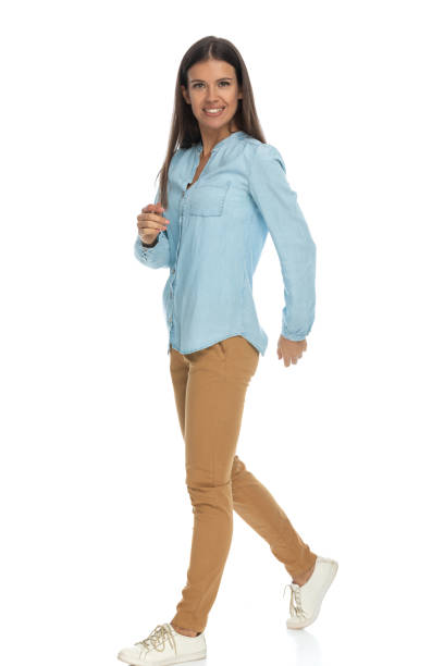istock casual woman walking one way and looking at the camera 1303671793