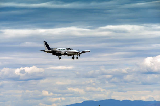 Cessna 340 twin engined light aircraft against a cloudy sky Everett, Washington State, USA - June 2018: Cessna 340 twin engined light aircraft (registration N700DK) with wheels and flaps down coming into land at Everett. everett washington state photos stock pictures, royalty-free photos & images