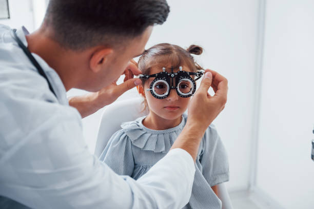 istock Testing vision. Young ophthalmologist is with little female visitor in the clinic 1303674614