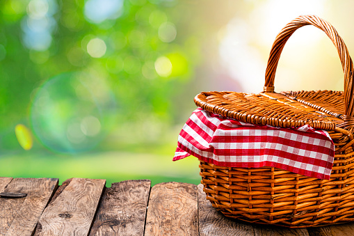 Springtime: Picnic basket shot on rustic wooden table with defocused lush foliage at background. The composition is at the right of an horizontal frame leaving useful copy space for text and/or logo at the left.
High resolution 42Mp outdoors digital capture taken with Sony A7rII and Sony FE 90mm f2.8 macro G OSS lens