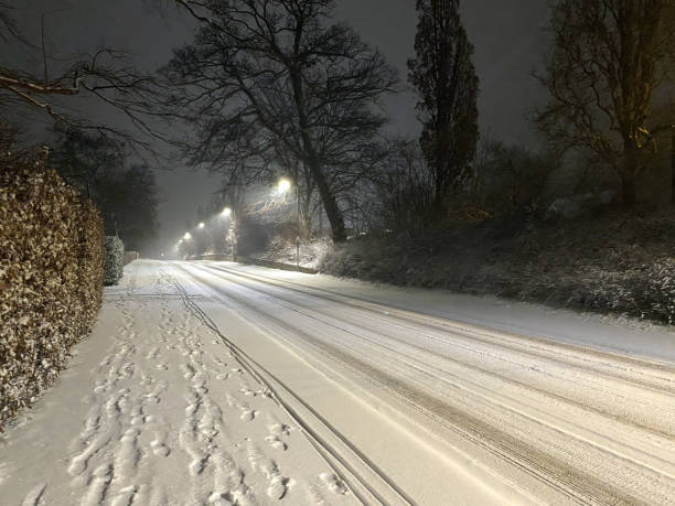 istock Footprints in the snow. Empty street at dusk during COVID-19 lock down. 1303675173