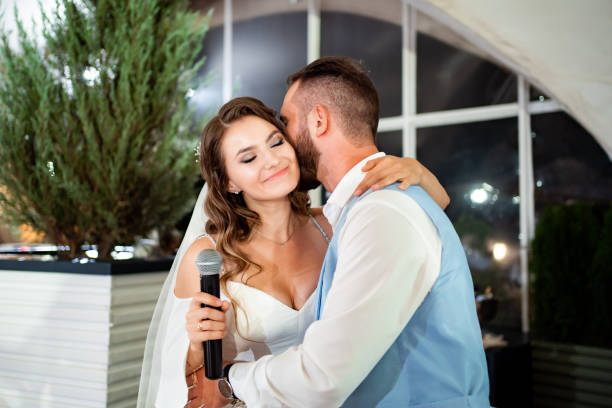 istock The bride gives a speech into the microphone and congratulates the groom. 1303676568