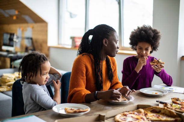 istock Family eating pizza together at home 1303676795