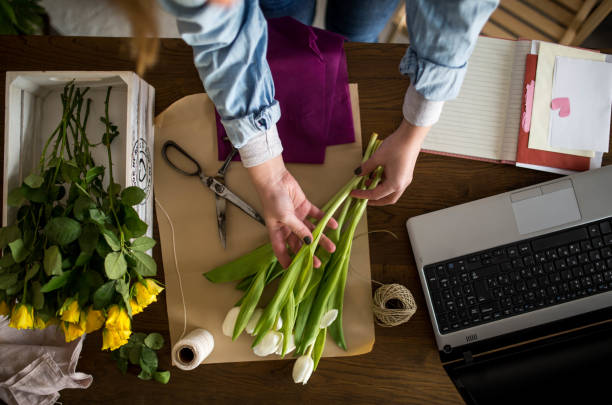 istock Young woman arranging a bouquet 1303677828