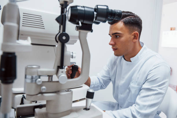 istock Oculist tests vision of patient by using special modern machine 1303678097
