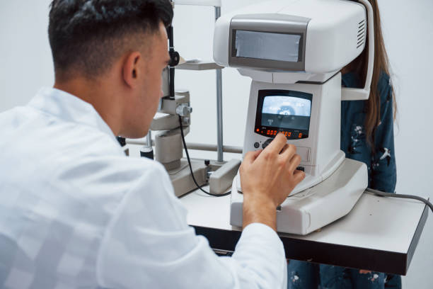 istock Oculist tests vision of patient by using special modern machine 1303678140