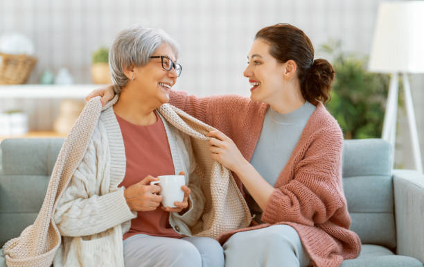 mother and her adult daughter - senior adult winter senior women daughter imagens e fotografias de stock