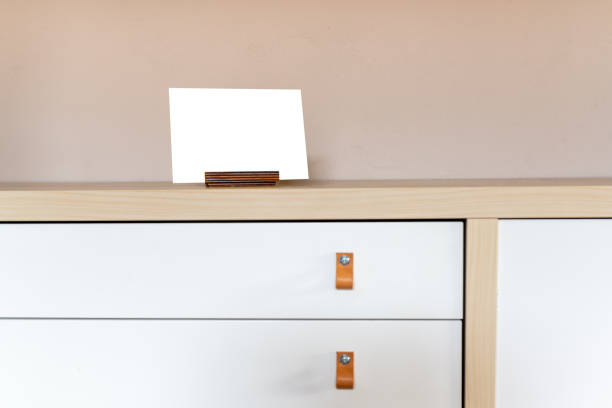 istock mockup, template for postcard in a postcard holder. Scandinavian, minimalist interior 1303684061