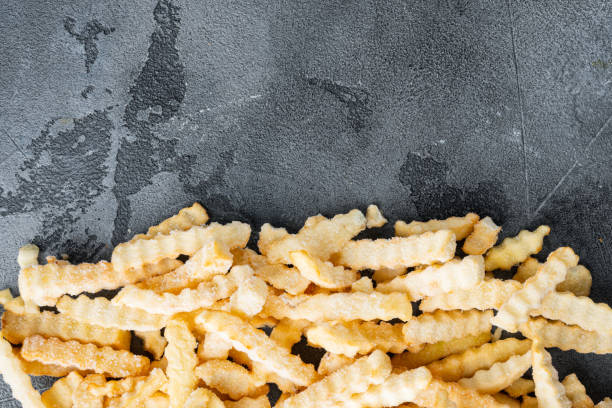 istock Frozen fries, on gray background, top view flat lay , with copyspace  and space for text 1303684418