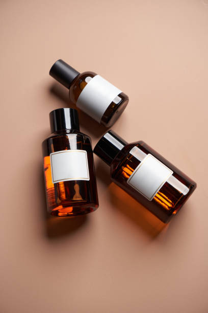 istock Essential oil bottles on pastel color background with copy space 1303686927