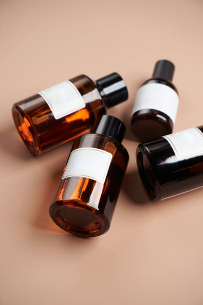 istock Essential oil bottles on pastel color background with copy space 1303686934