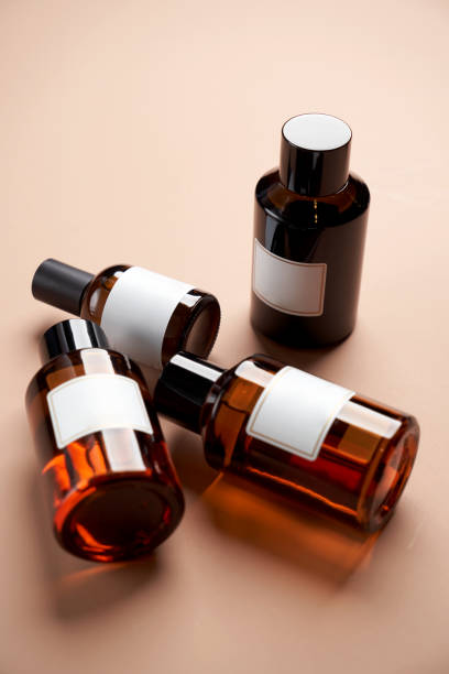 istock Essential oil bottles on pastel color background with copy space 1303686947