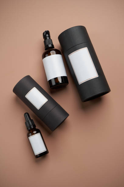 istock Essential oil bottles on pastel color background with copy space 1303686954