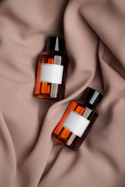 Essential oil bottles on pastel color background with copy space