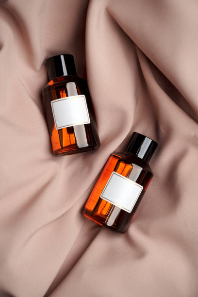 istock Essential oil bottles on pastel color background with copy space 1303686973