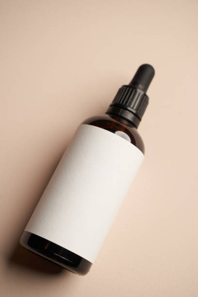istock Essential oil bottles on pastel color background with copy space 1303687009