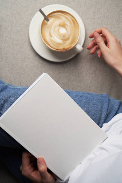 istock Girl reading book and drinking coffee, top view. 1303687096