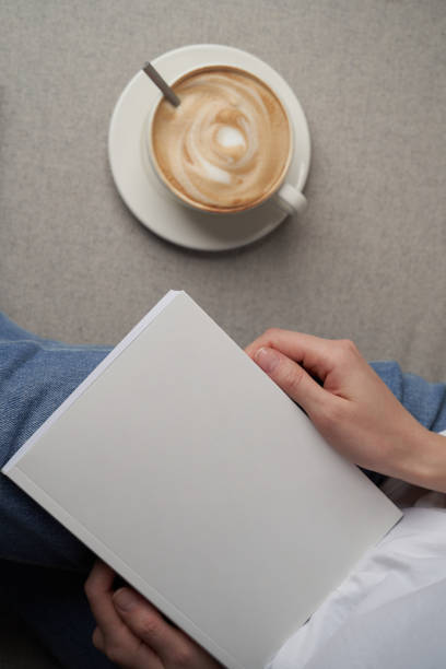 istock Girl reading book and drinking coffee, top view. 1303687106