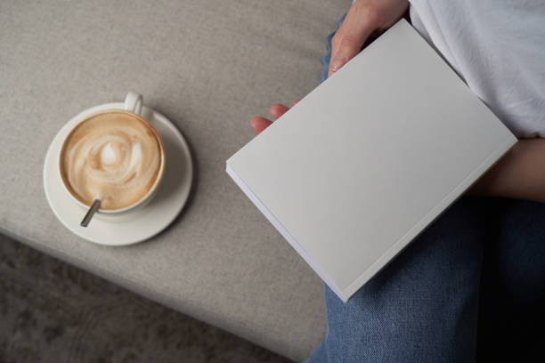 istock Girl reading book and drinking coffee, top view. 1303687107